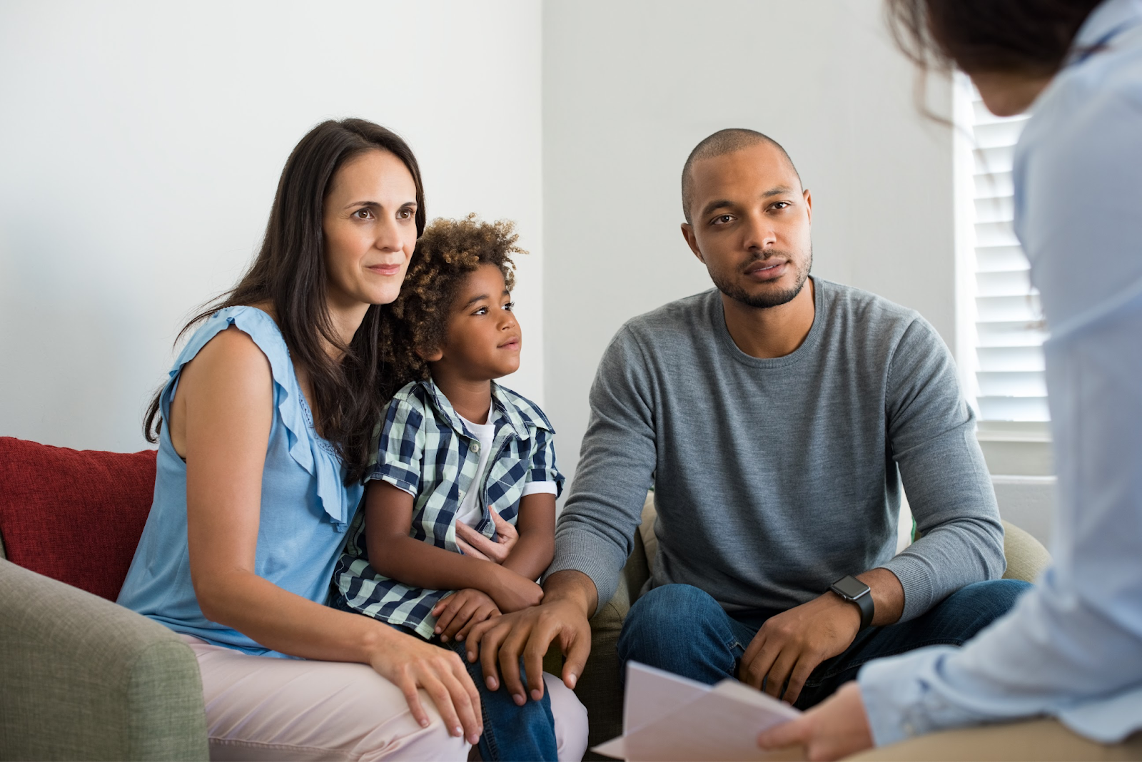 Two parents and their child in family counseling.