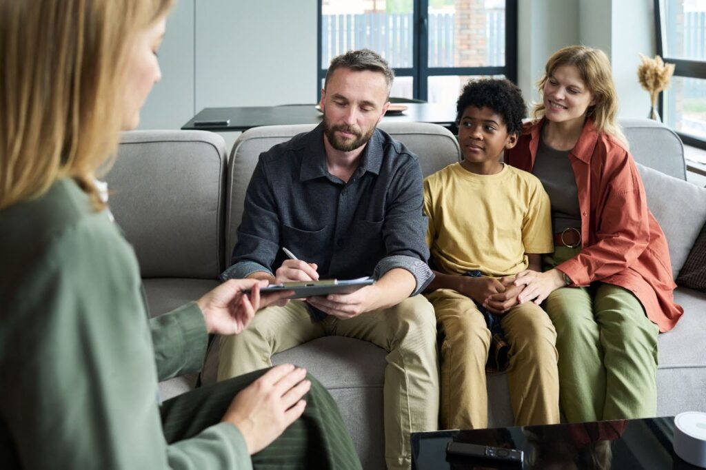 Family participating in ADHD therapy session in a relaxed setting.