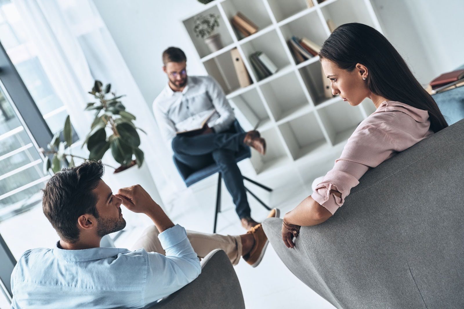 A couple undergoes professional counseling with a therapist.