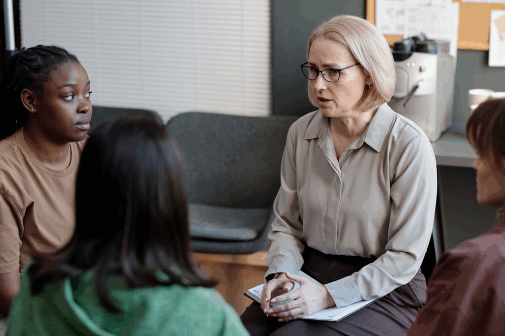 A psychologist advises teens during a group session of professional counseling.