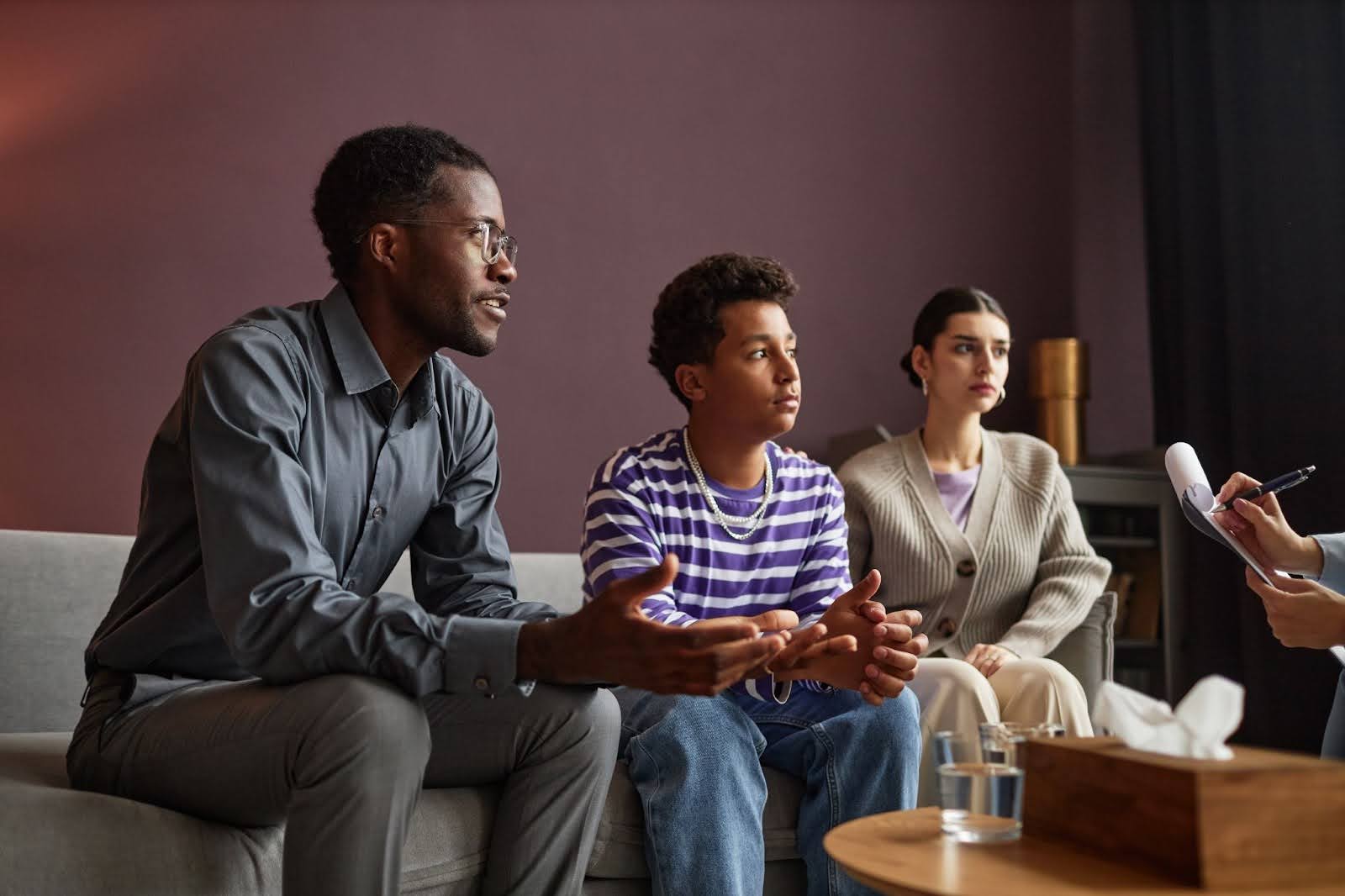 Two parents and their child visit a family counseling center.